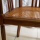 Antique armchair and stool with caned seat and fluted legs
