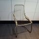 Tubular metal chair covered with gilding
