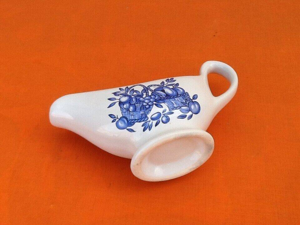 White porcelain gravy boat, fruit basket decor