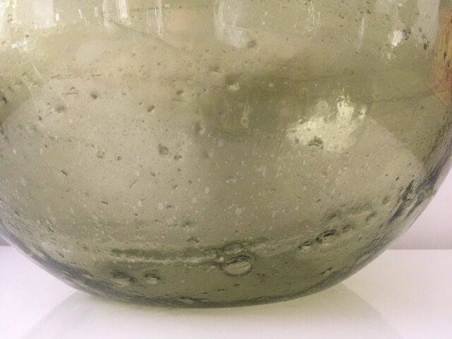 Old demijohn full of bubbles
