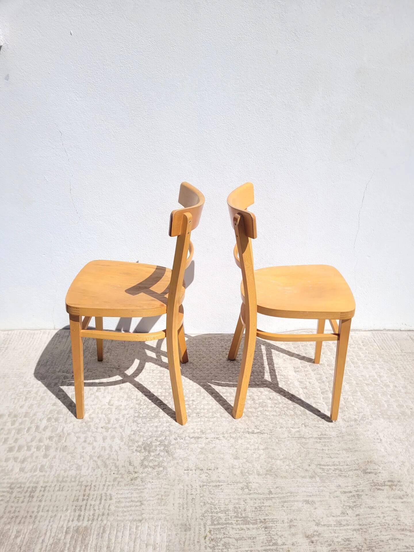 Pair of bistro chairs in light beech.