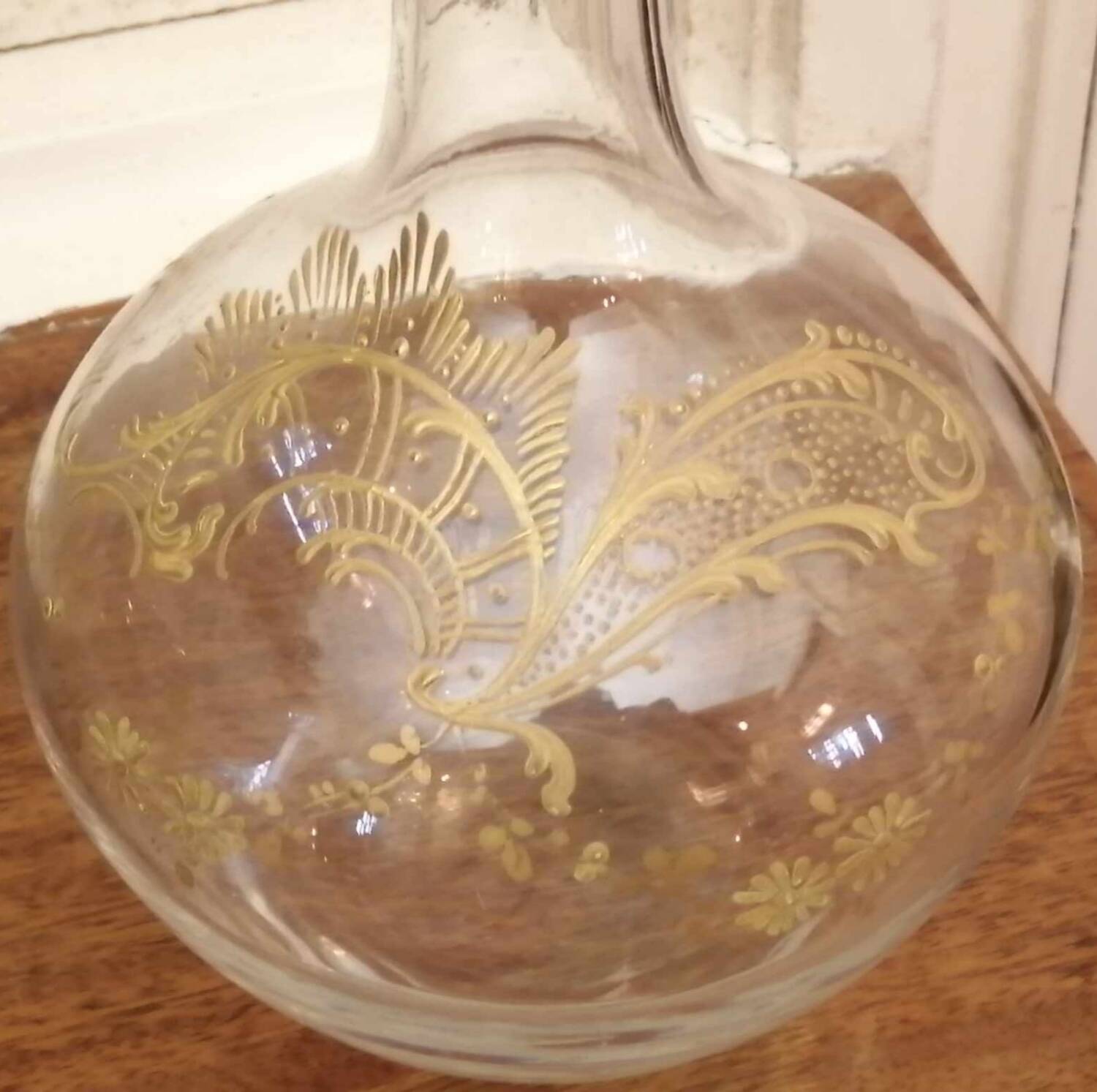 Old crystal decanter with gold decoration