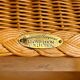 Natural Lloyd Loom paper cord rattan round table with brass-capped legs by Vincent Sheppard