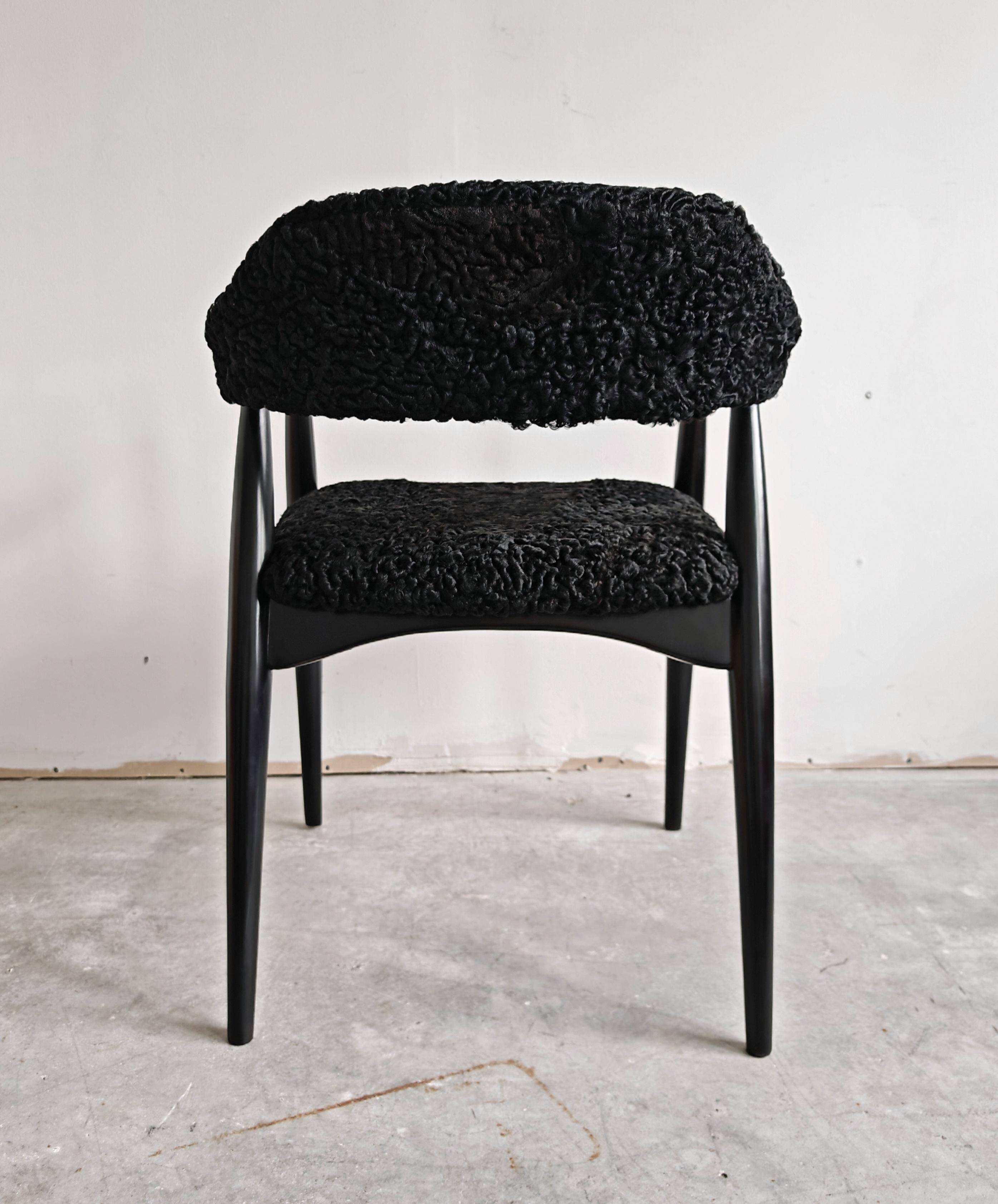 Pair of Mid Century Modern armchairs in astrakhan leather.