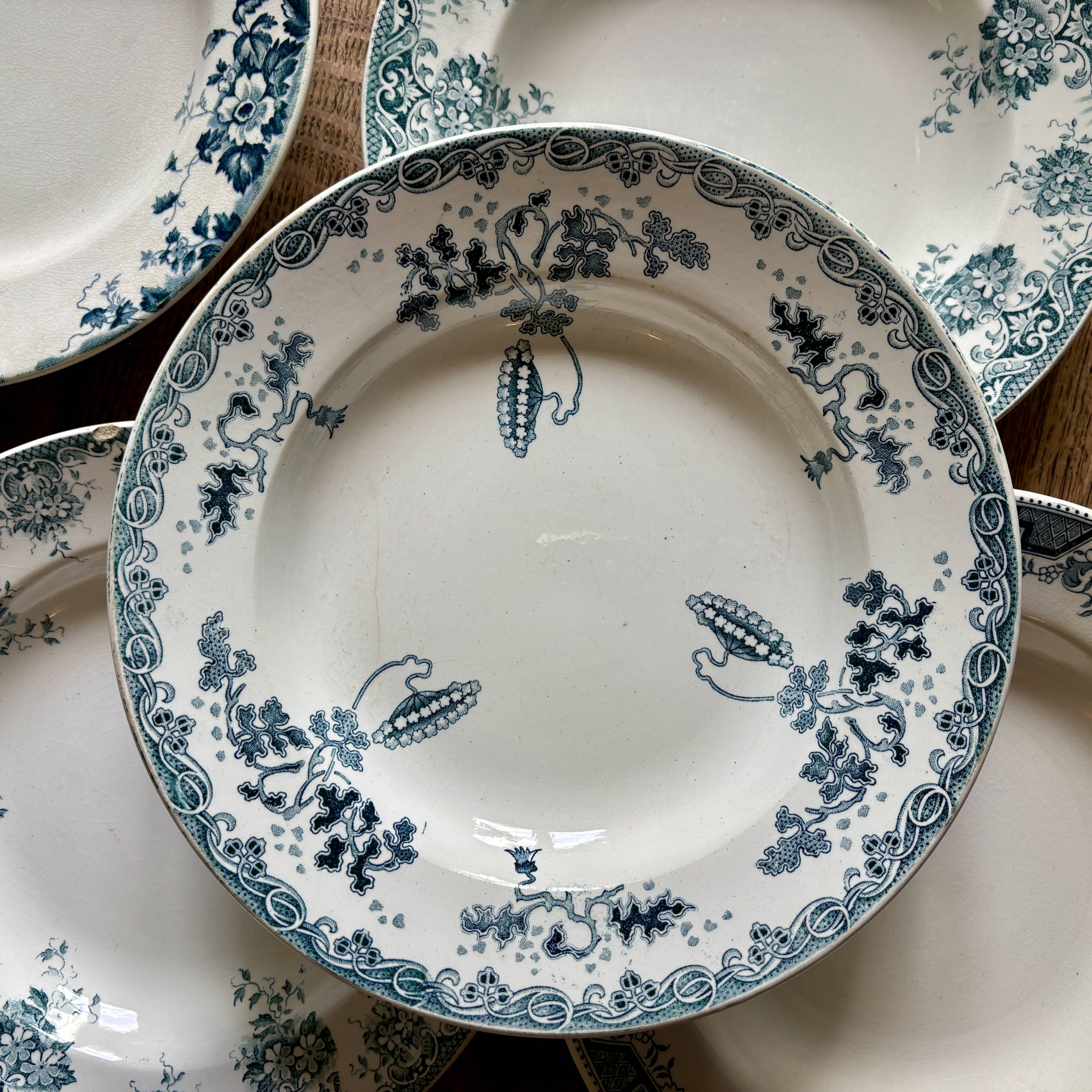Set of 8 mismatched antique ironstone deep plates.