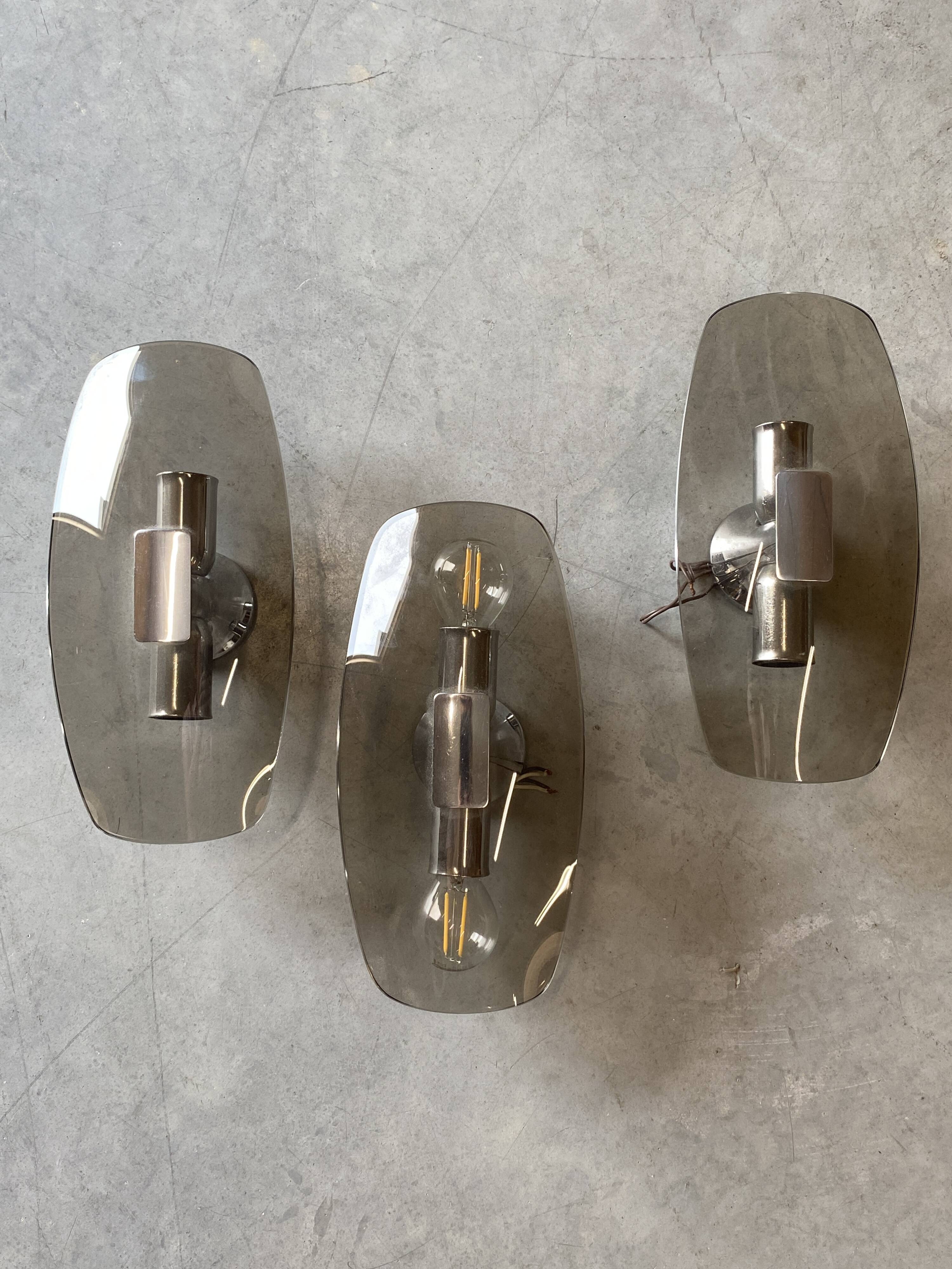 Trio of vintage chrome and smoked glass wall sconces