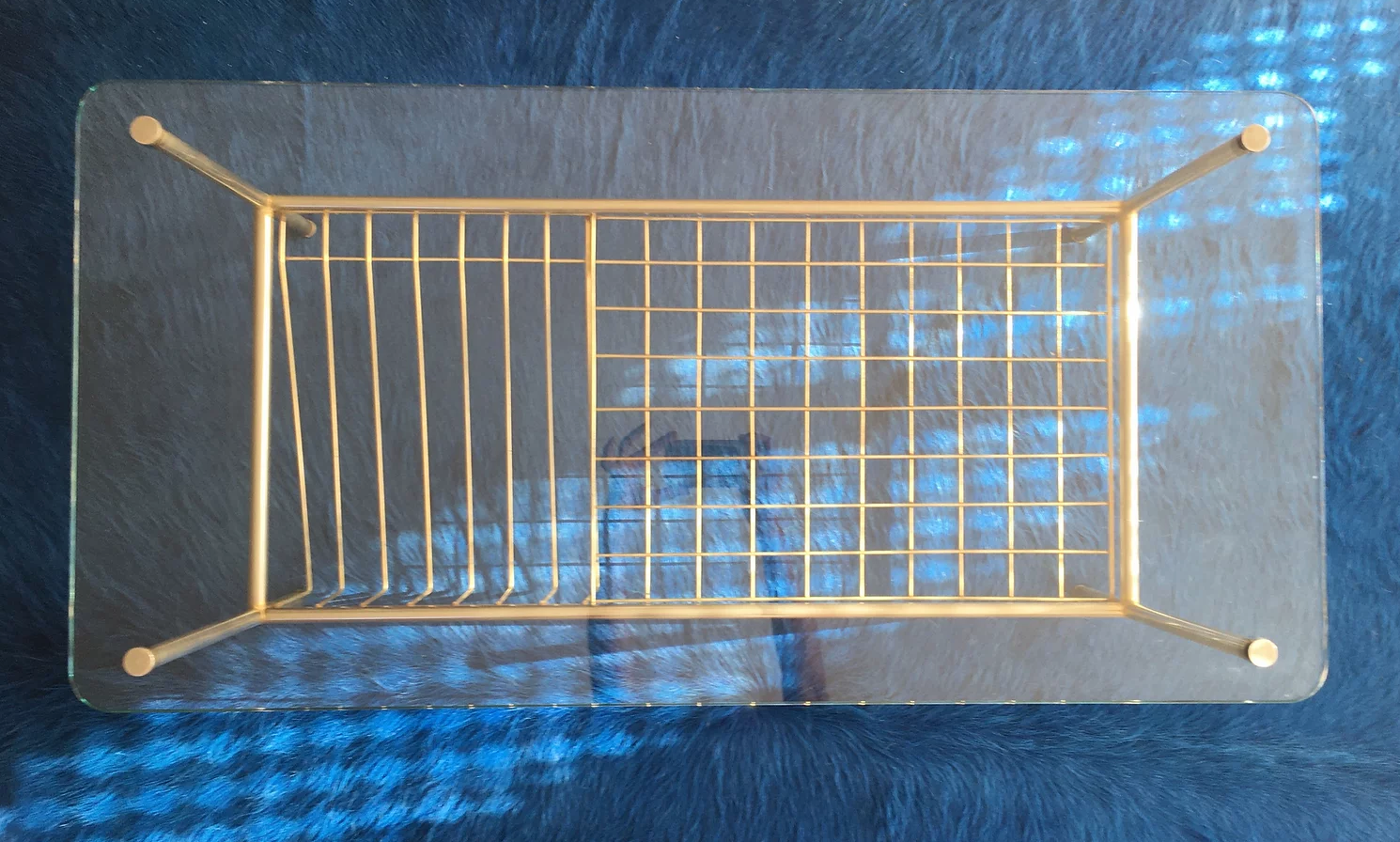 Glass coffee table with gold metal magazine holder