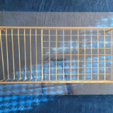 Glass coffee table with gold metal magazine holder