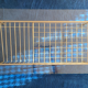 Glass coffee table with gold metal magazine holder