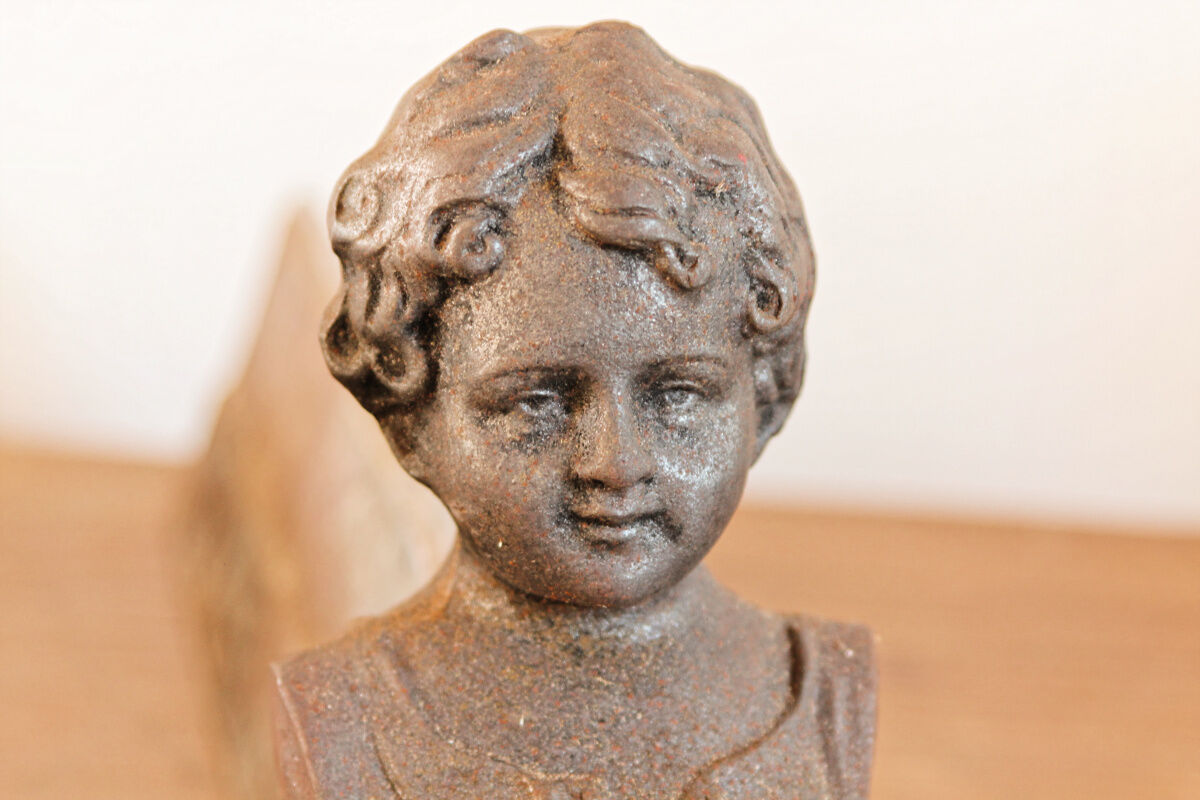 Pair of cast iron chenets, Love victorious