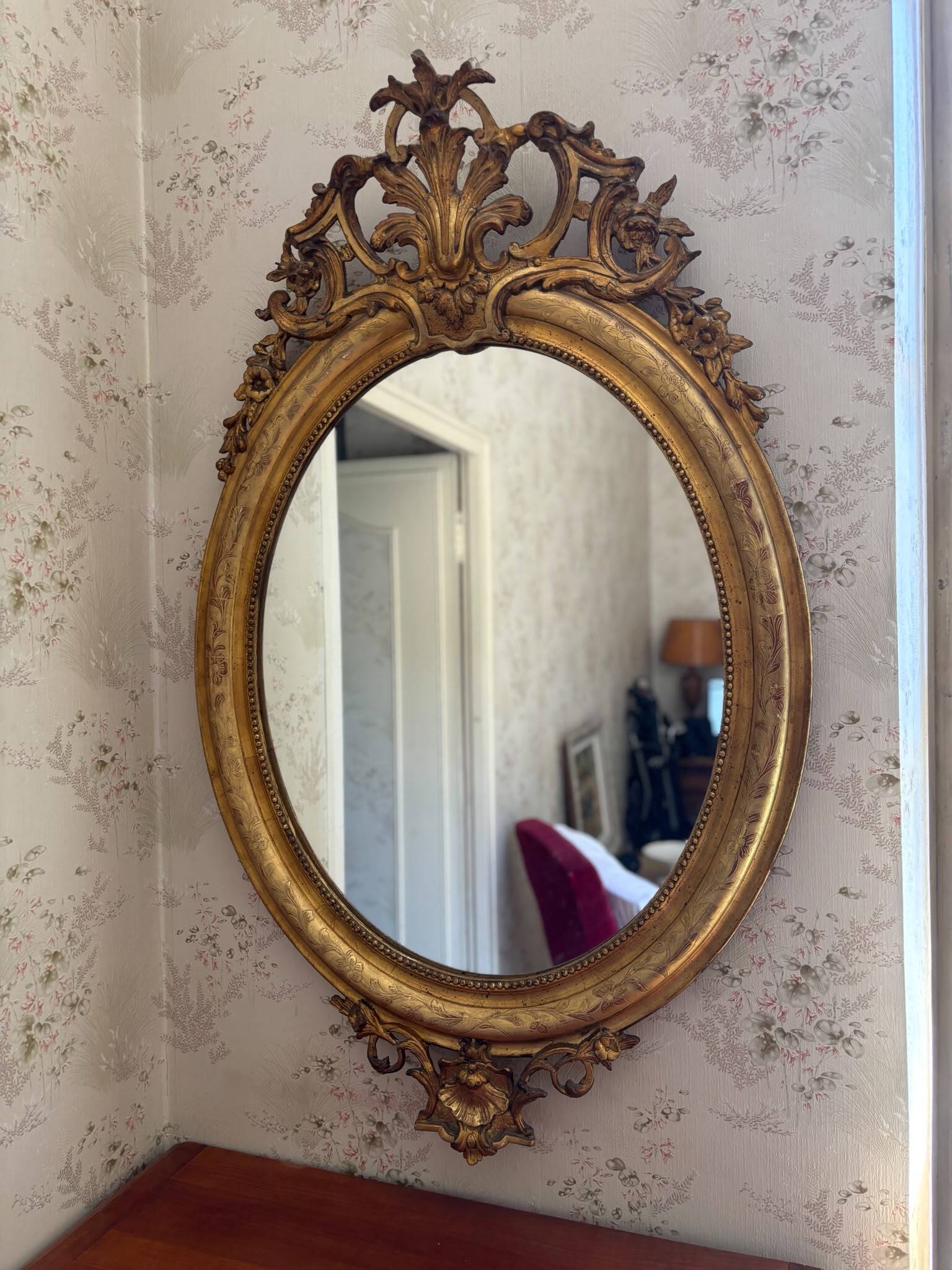 Golden oval mirror