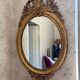 Golden oval mirror