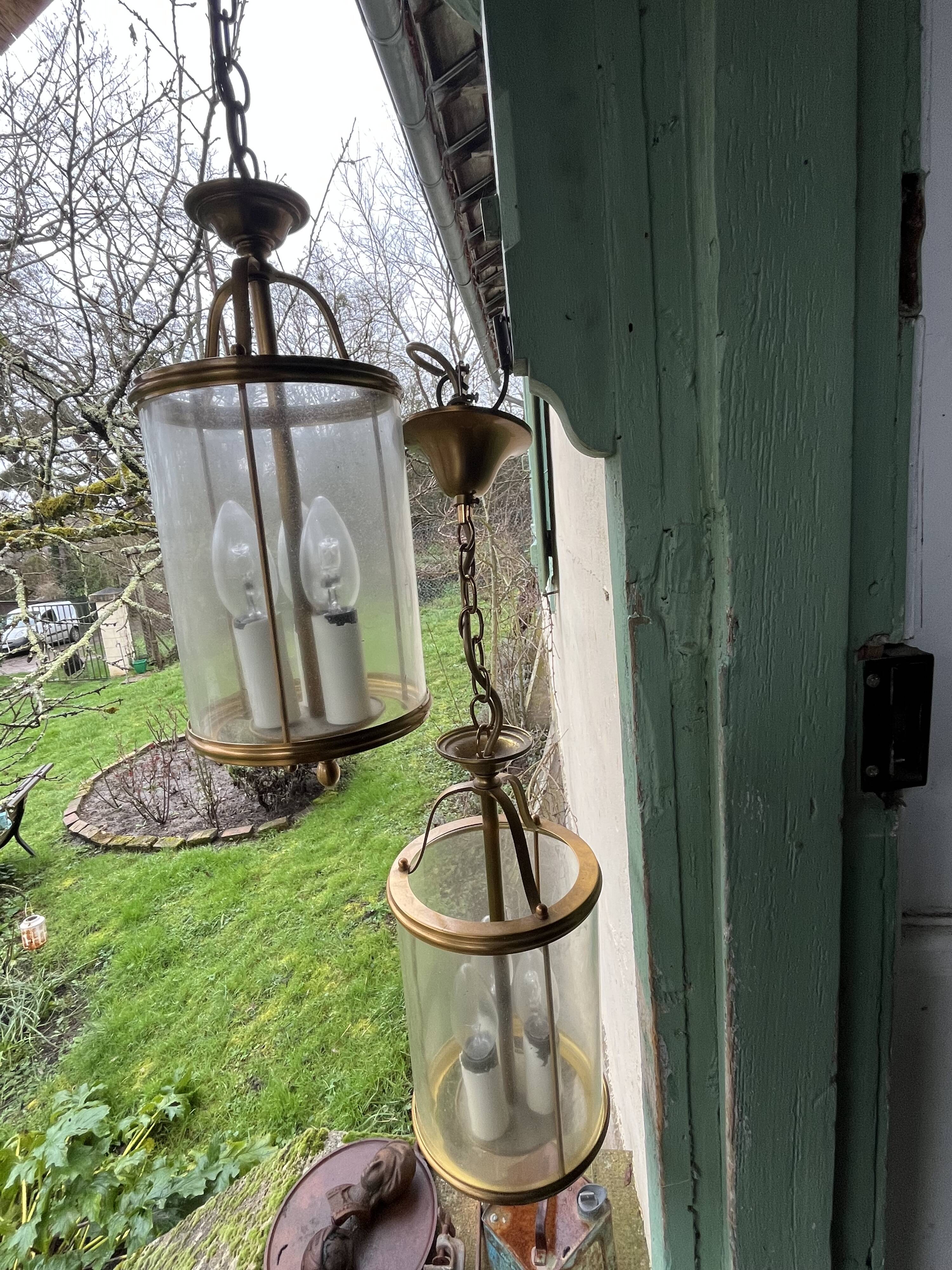 Pair of glass and brass chandeliers