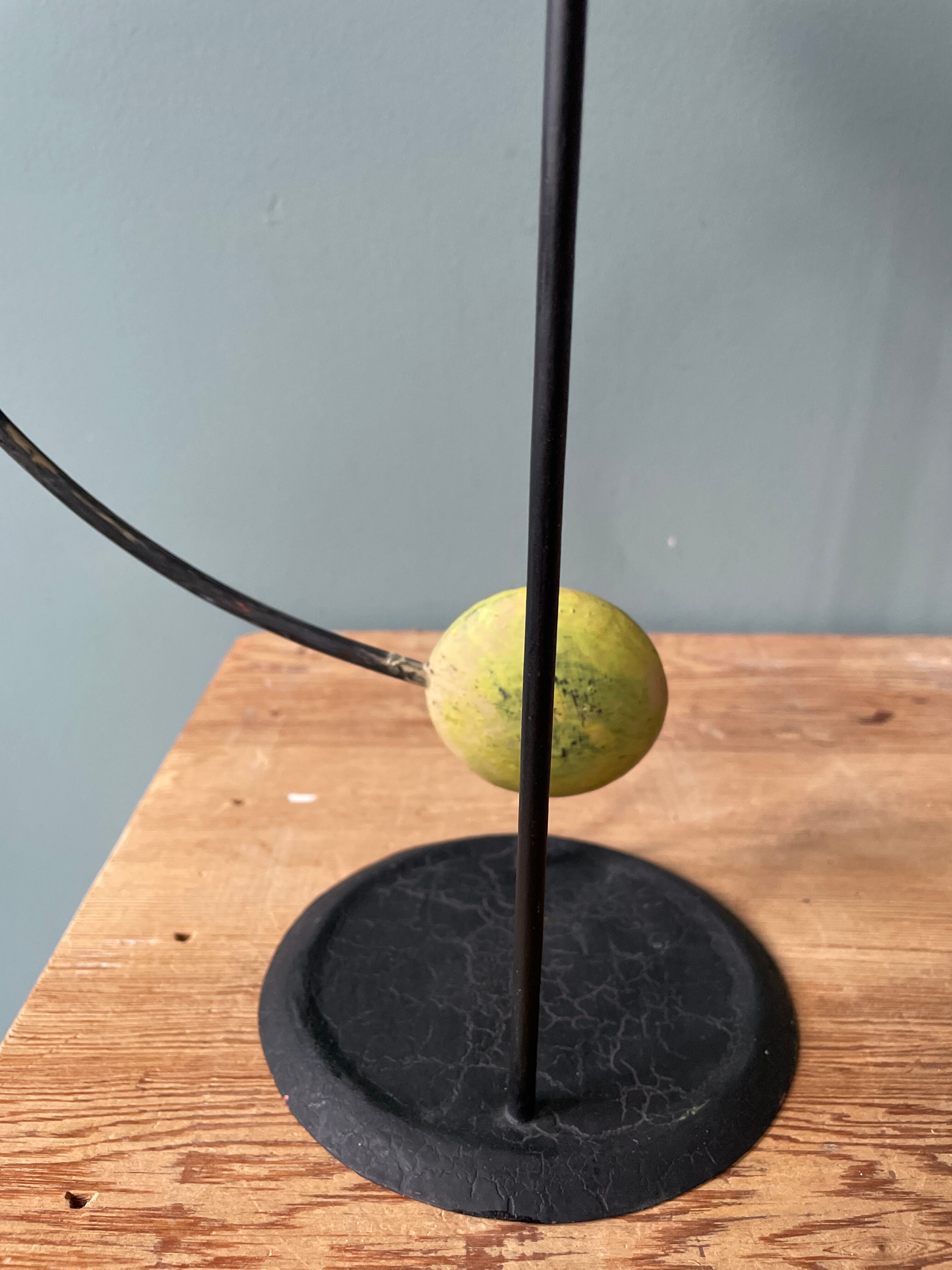 Old painted sheet metal pendulum toy