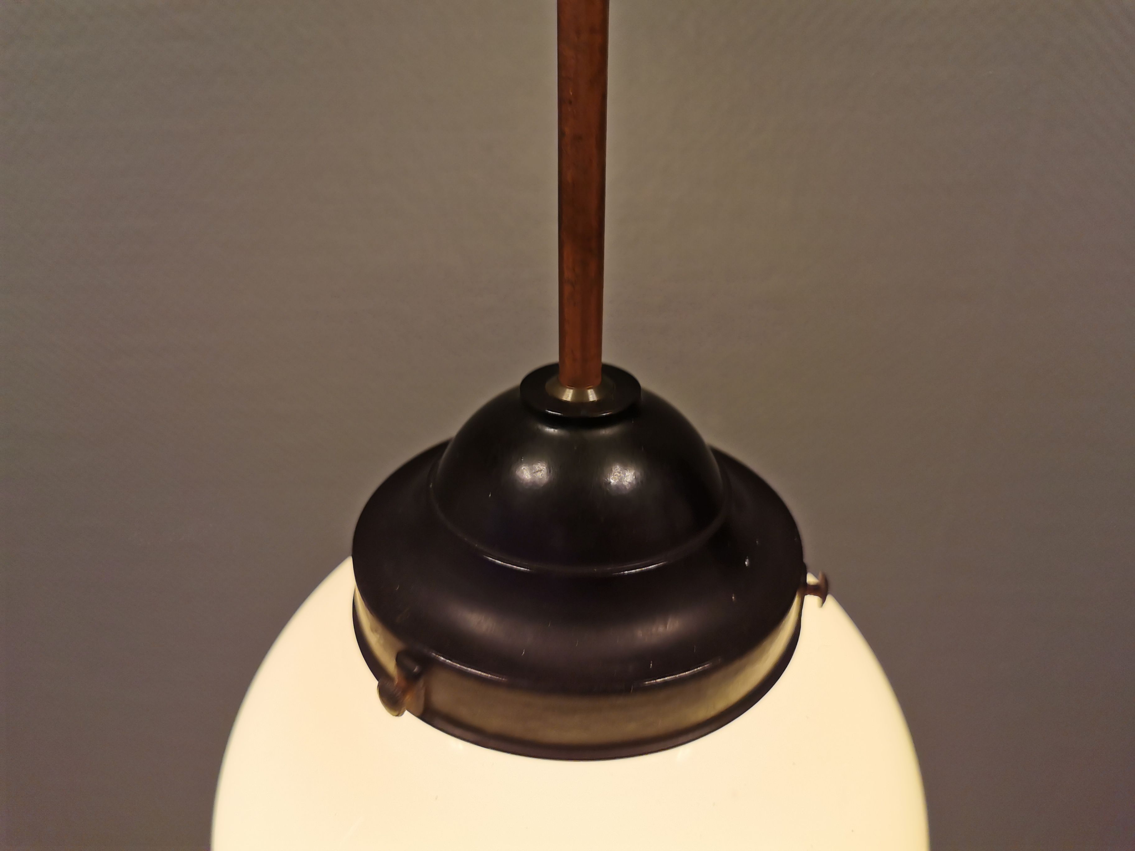 Small Art Deco hanging lamp in cream coloured glass and bakelite top.