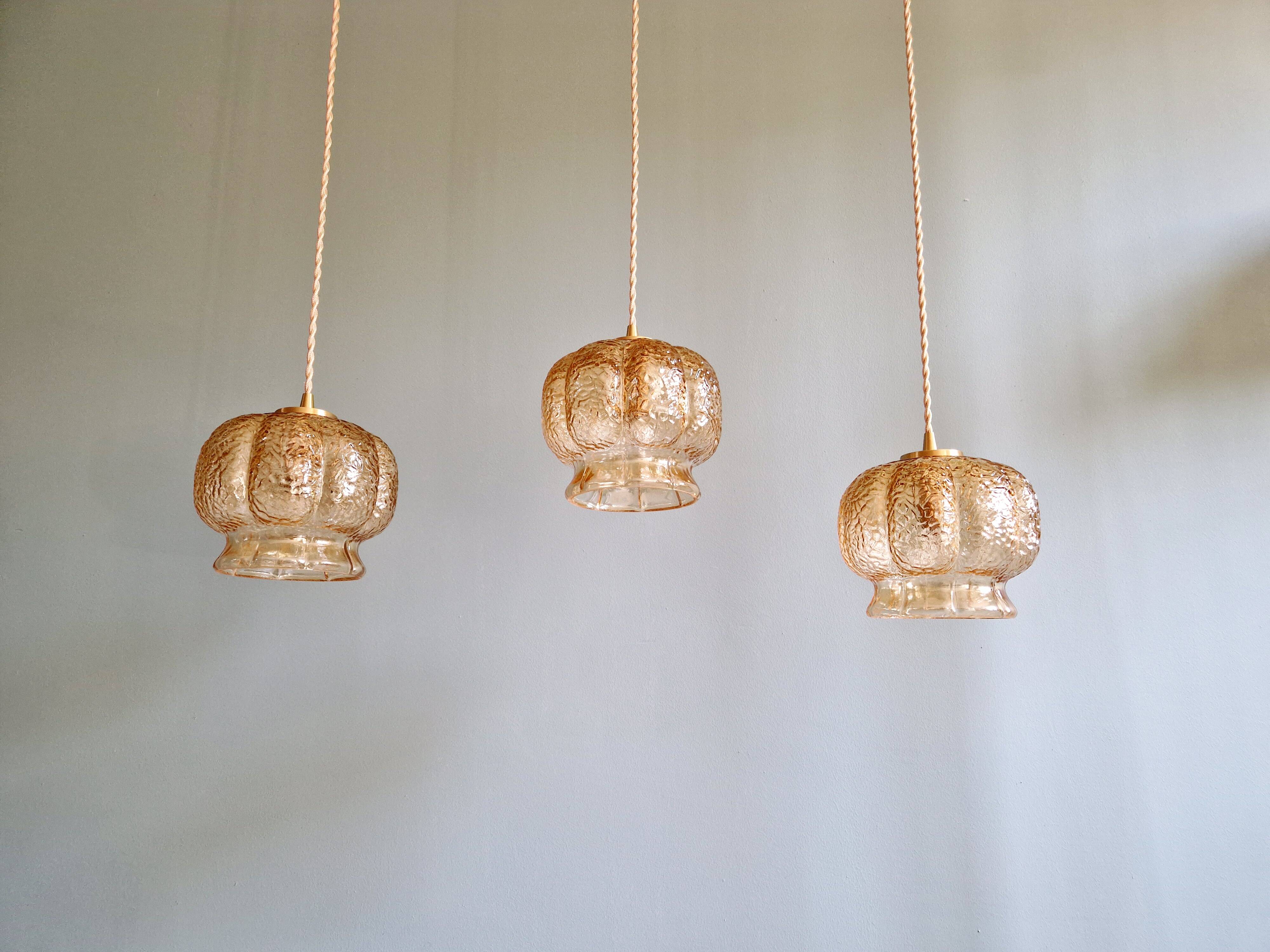 Vintage trio of amber glass pendants, 1960s-70s.