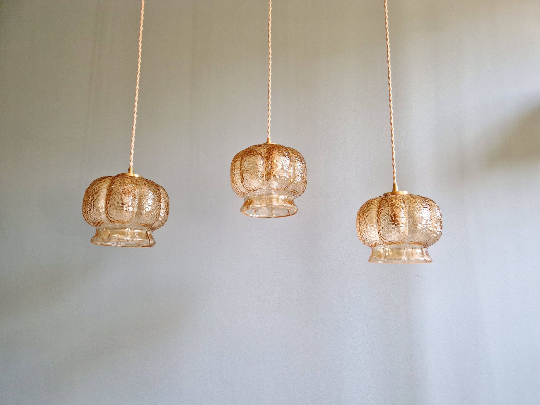 Vintage trio of amber glass pendants, 1960s-70s.