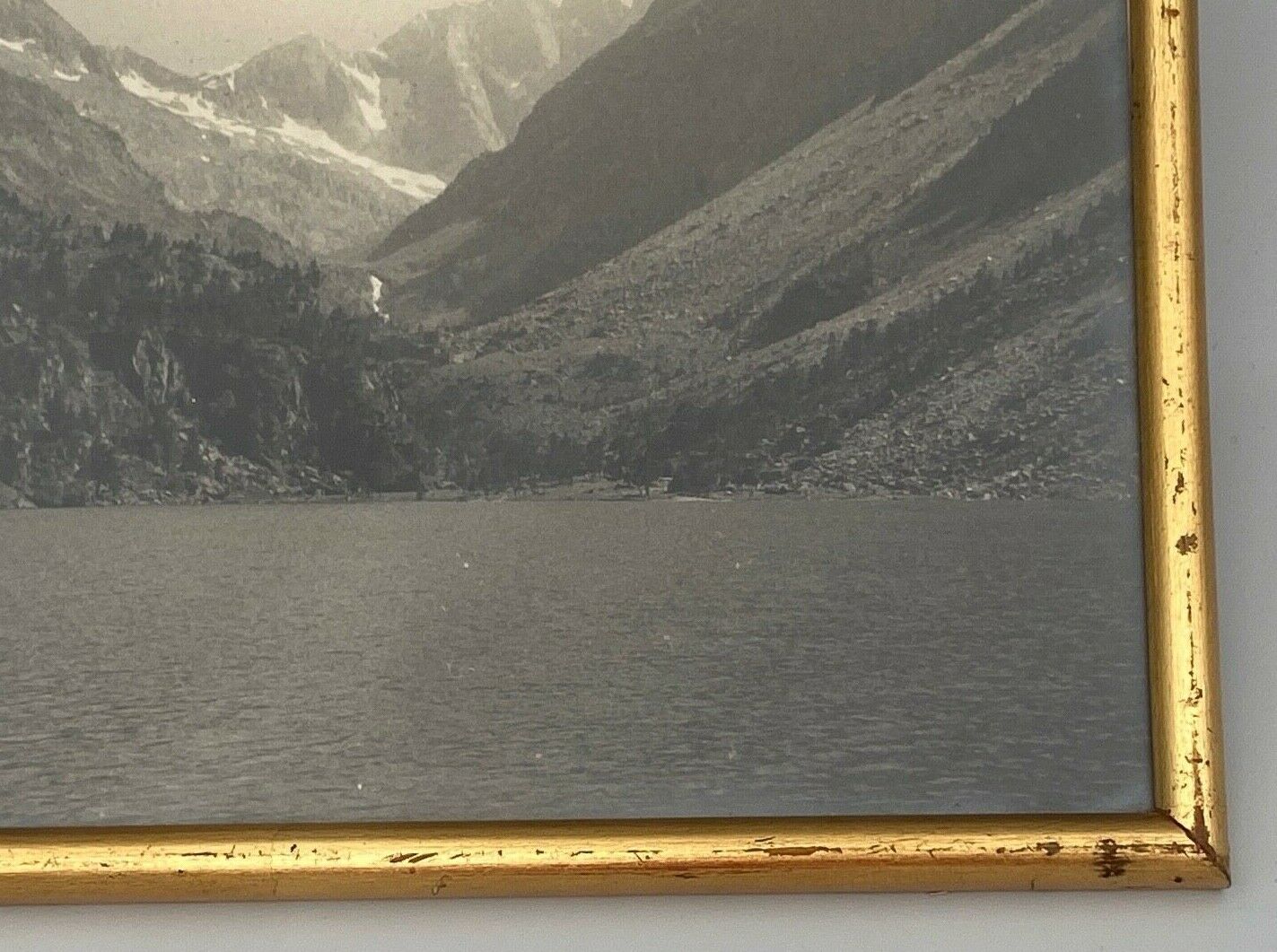 Photo in black and white mountain lake in golden frame