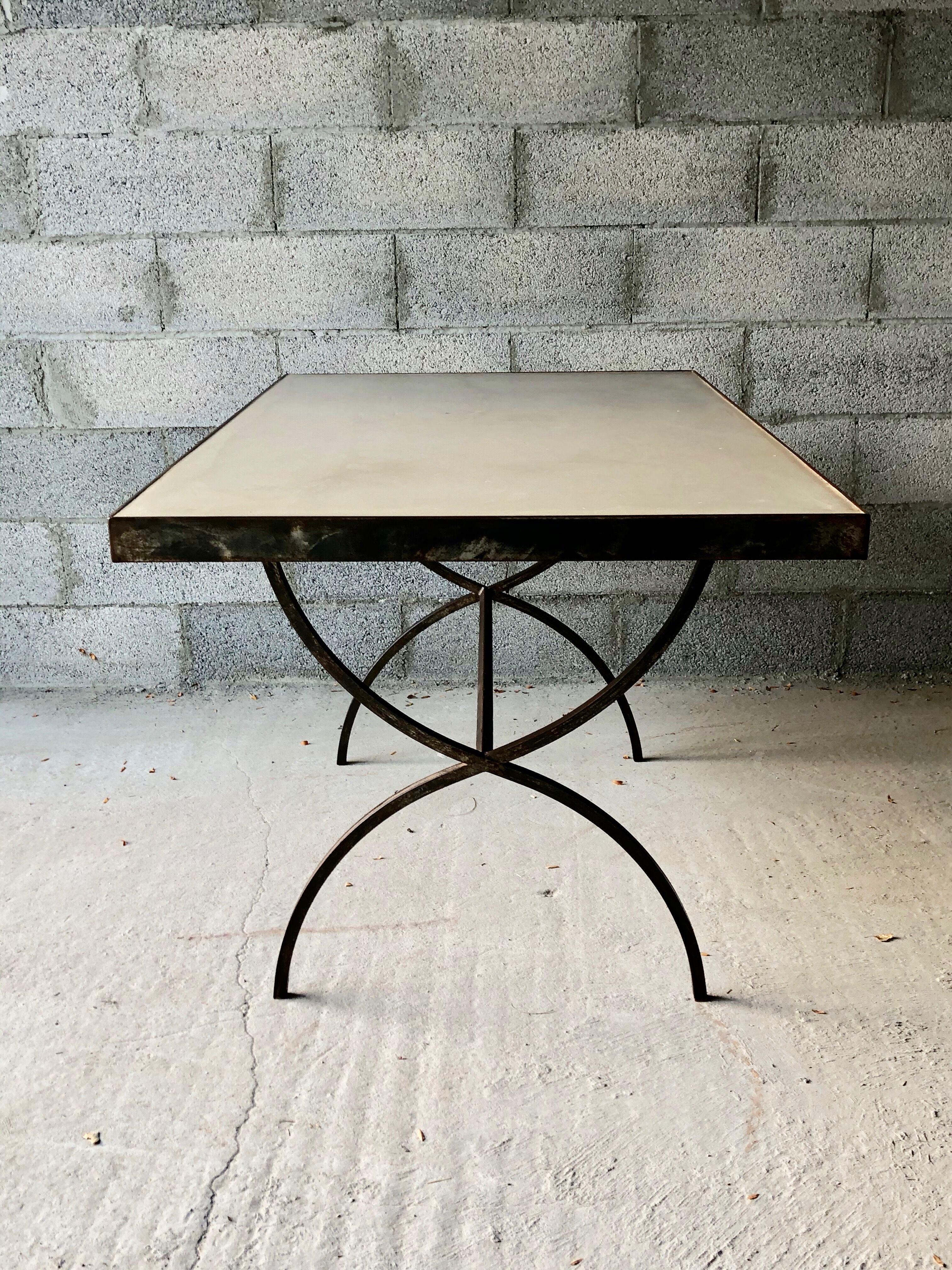 Table made of wrought iron and cement