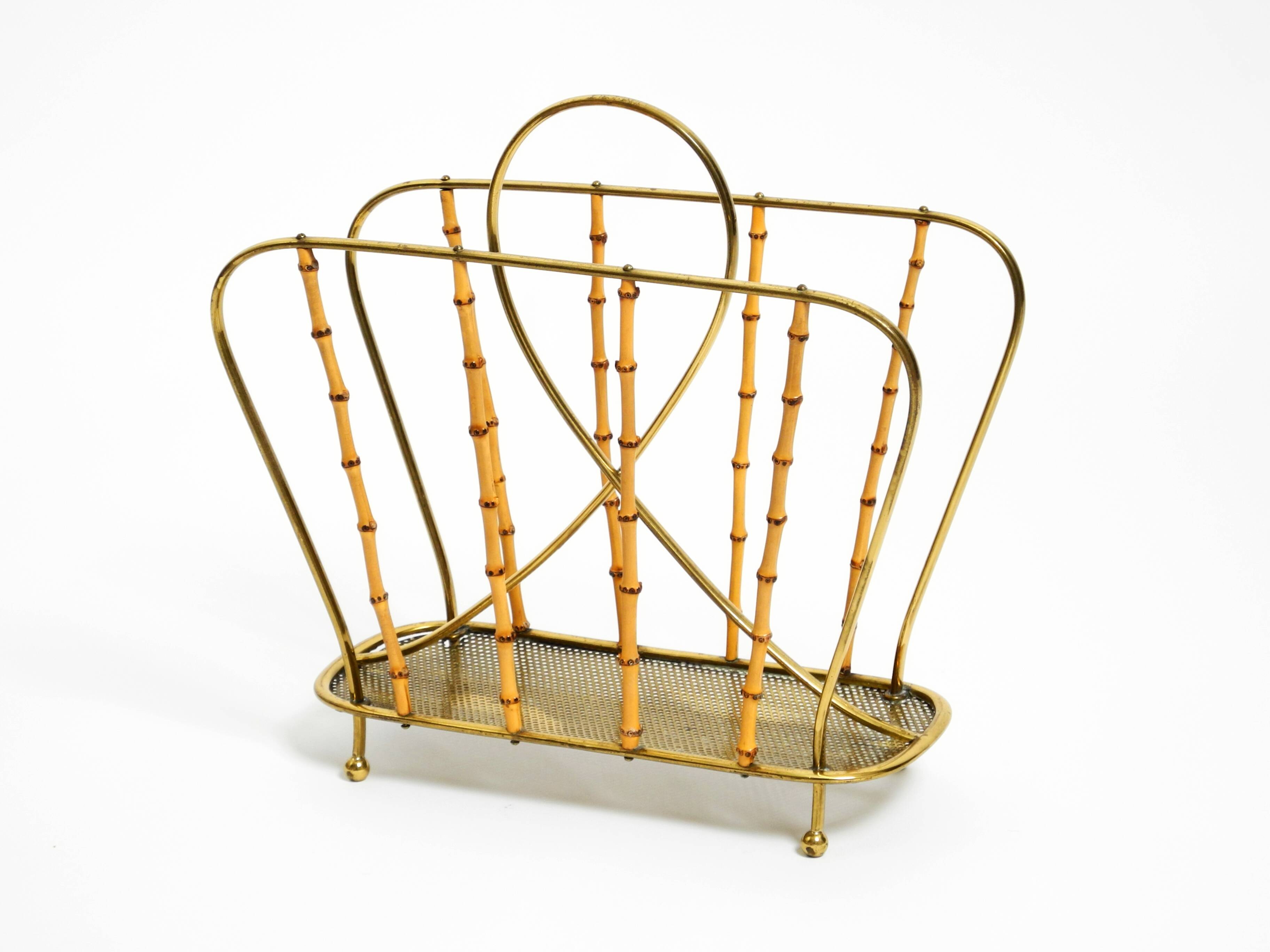 Rare Mid Century Modern magazine rack made of solid brass and genuine bambo