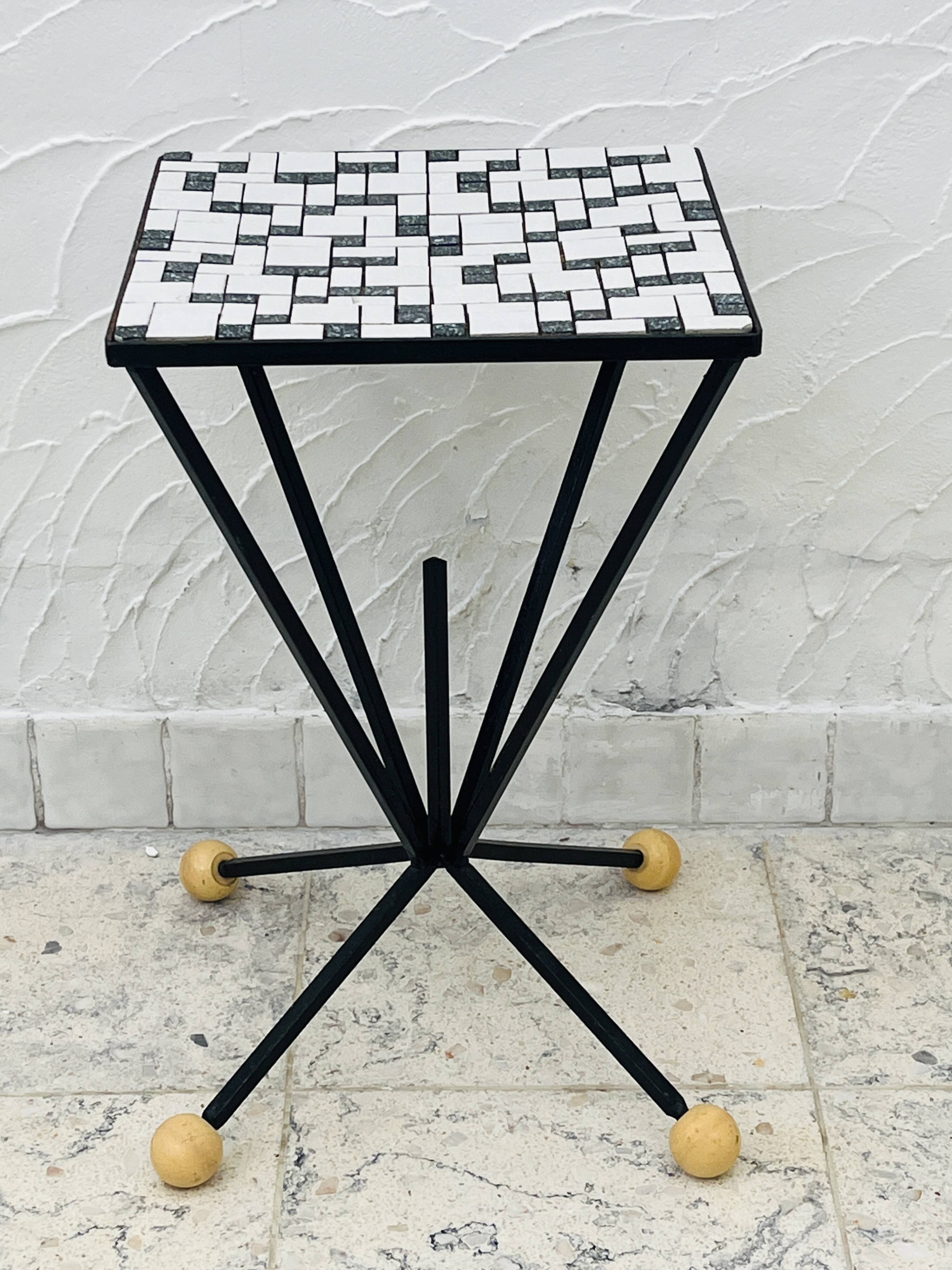 Wrought iron stela and black and white tiled top from the 1960s.