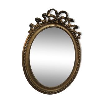 Oval mirror with gold patina