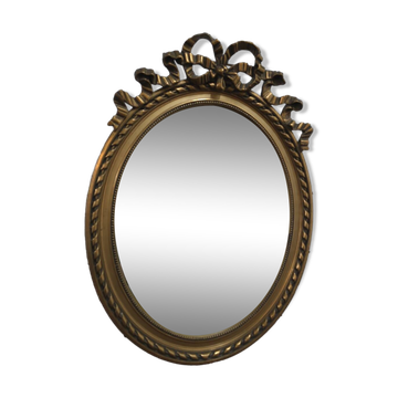 Oval mirror with gold patina