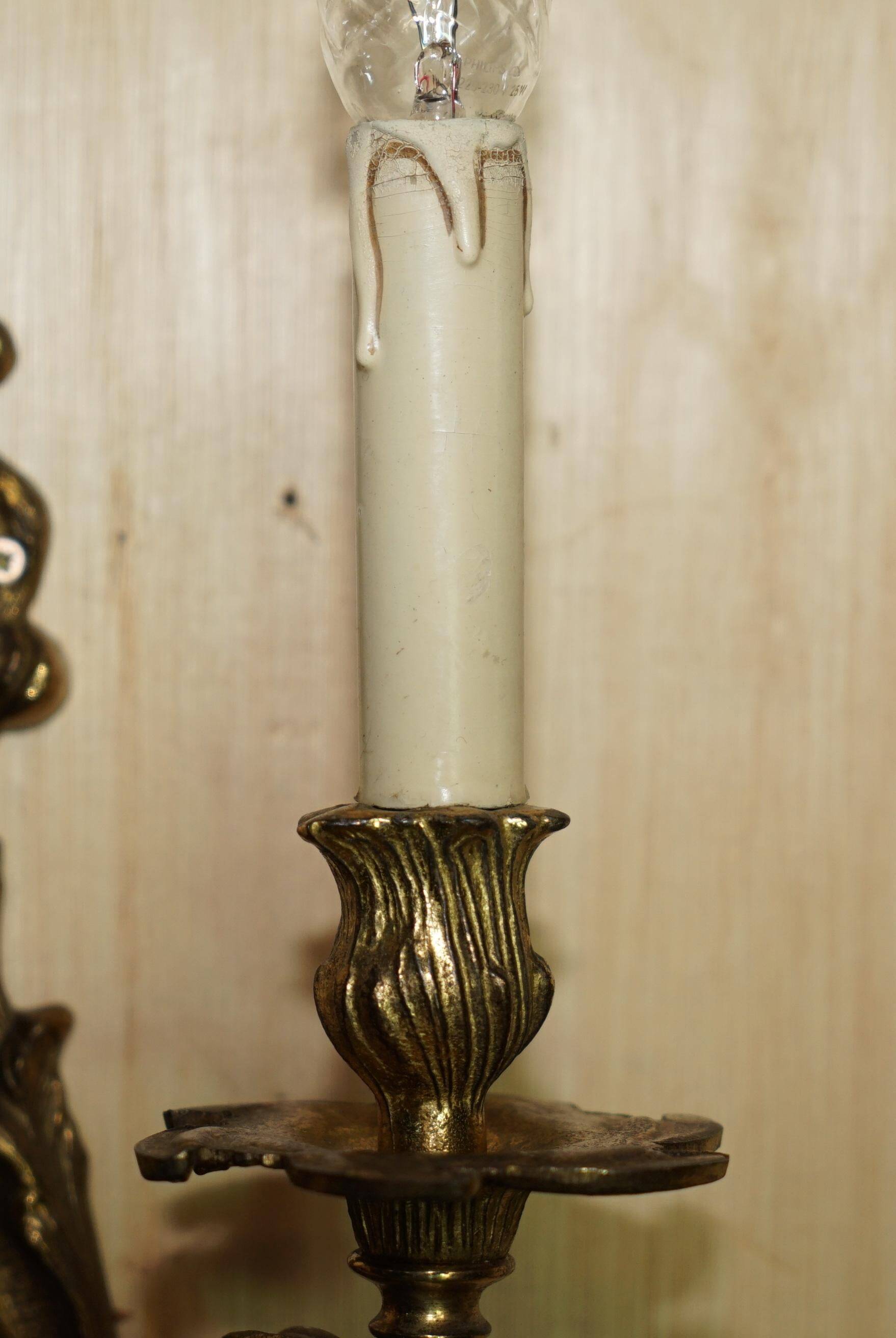 Pair of antique wall sconces from the 1920s in gilded bronze.
