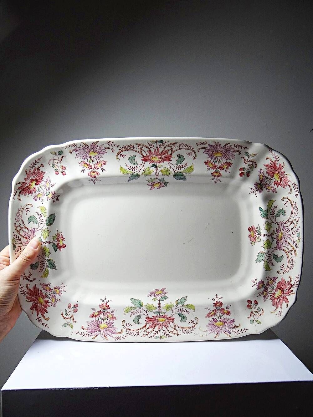 Antique Longchamp serving platter with polychrome daisies in ironstone.