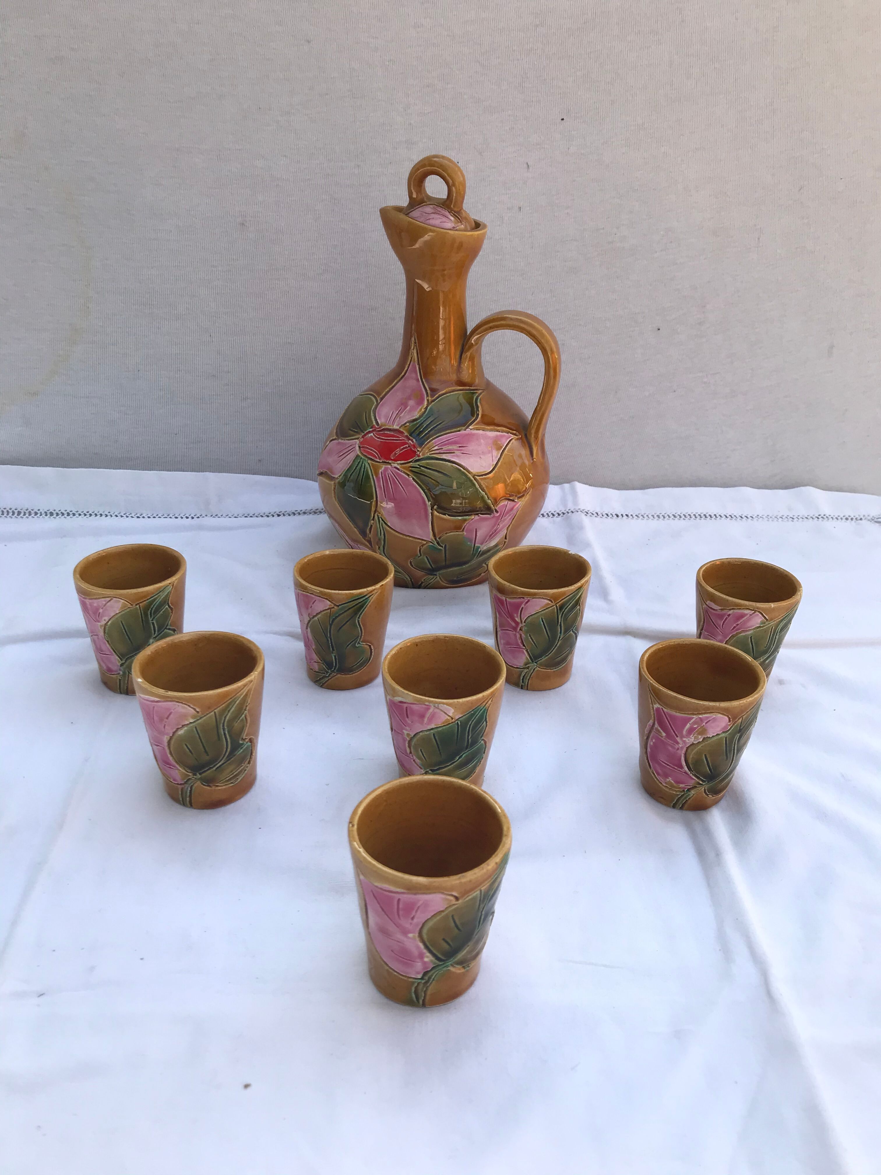 Old carafe with 8 ceramic glasses