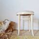 Vintage curved wooden stool in Baumann style, striped seat.