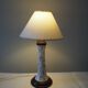 Table lamp for bedside use in earthenware with a wooden base.