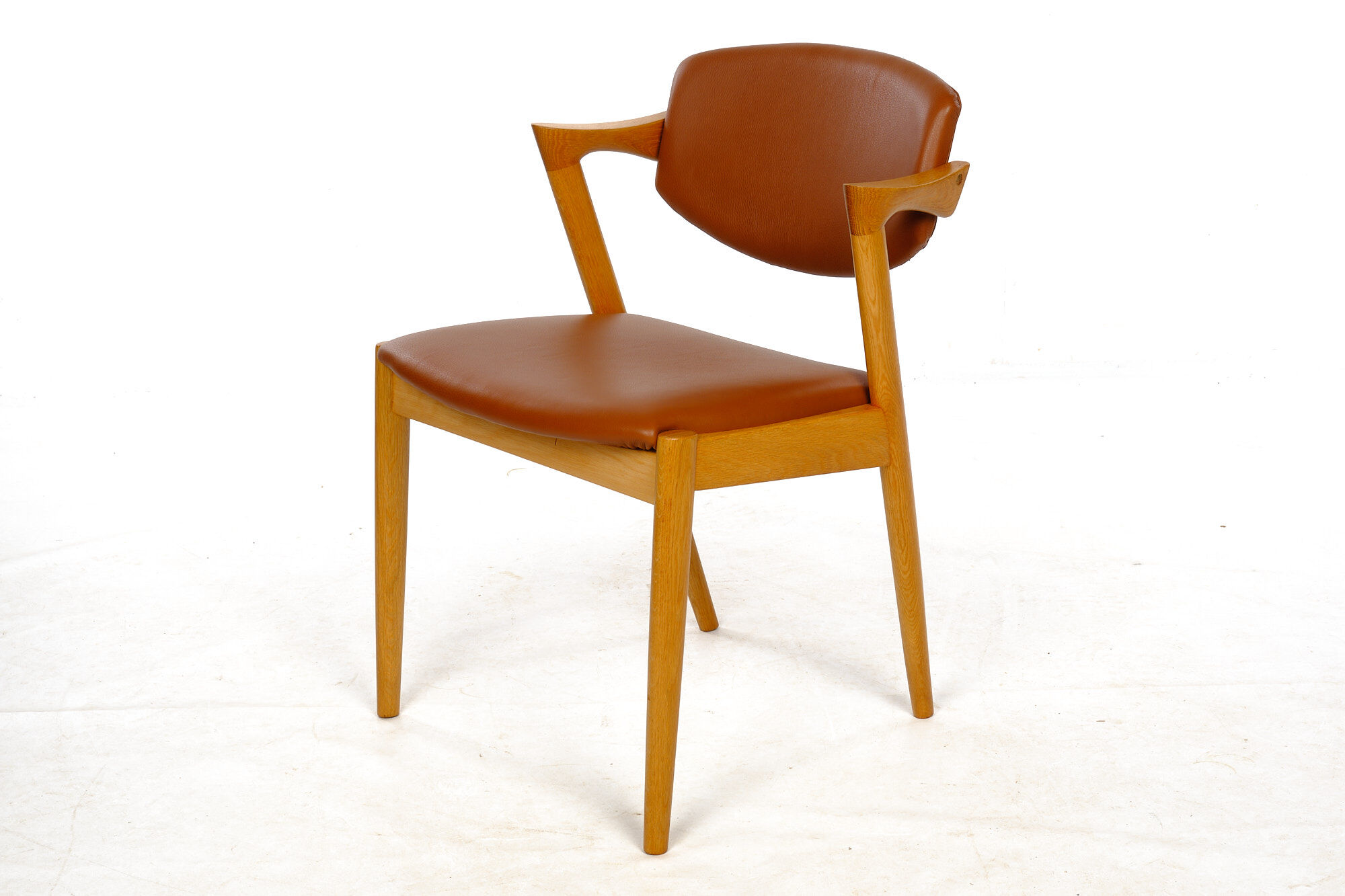 Four Kai Kristiansen oak chairs with new leather upholstery