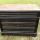 Blackened wooden chest of drawers with 5 drawers