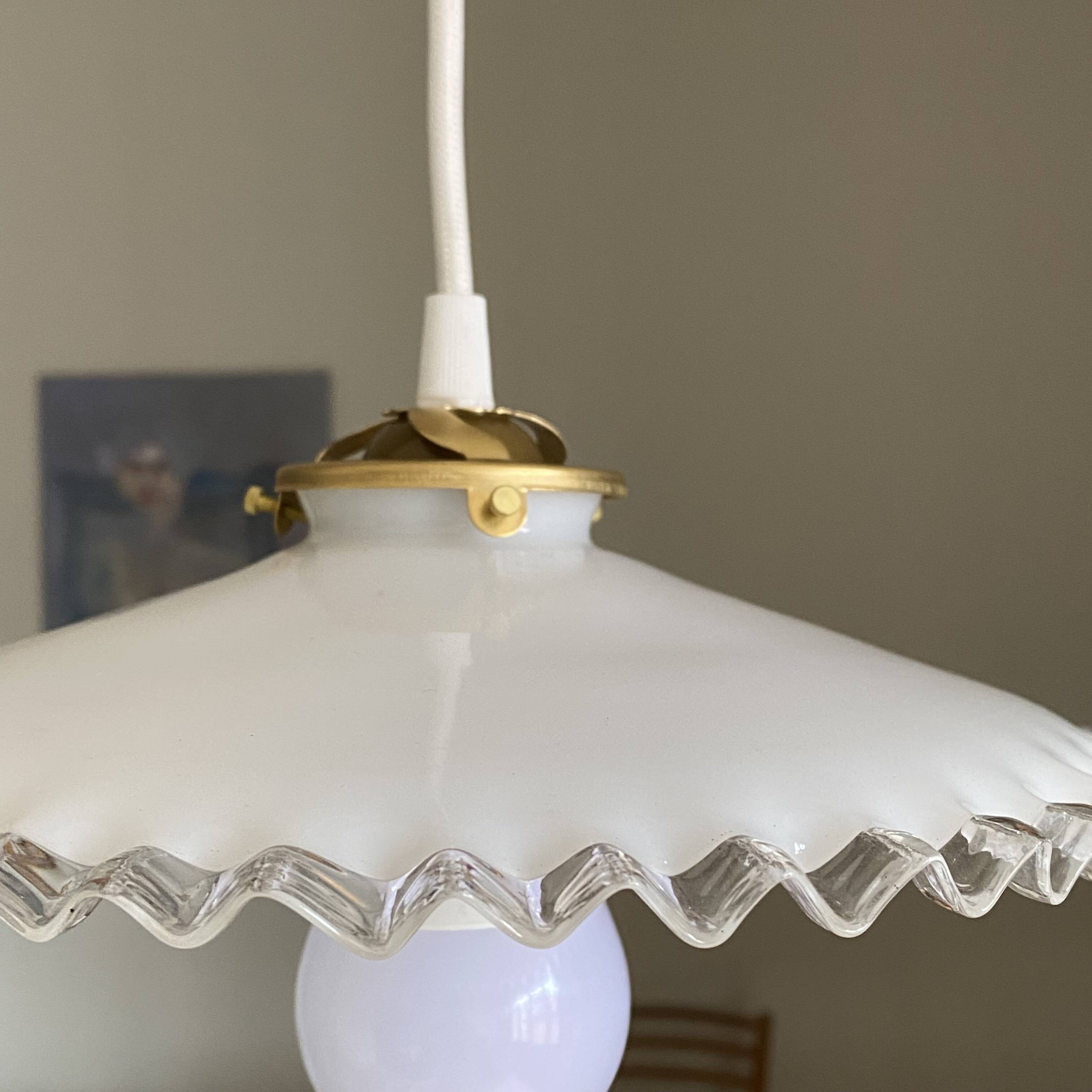 Old lampshade in white opaline glass with a wavy edge.