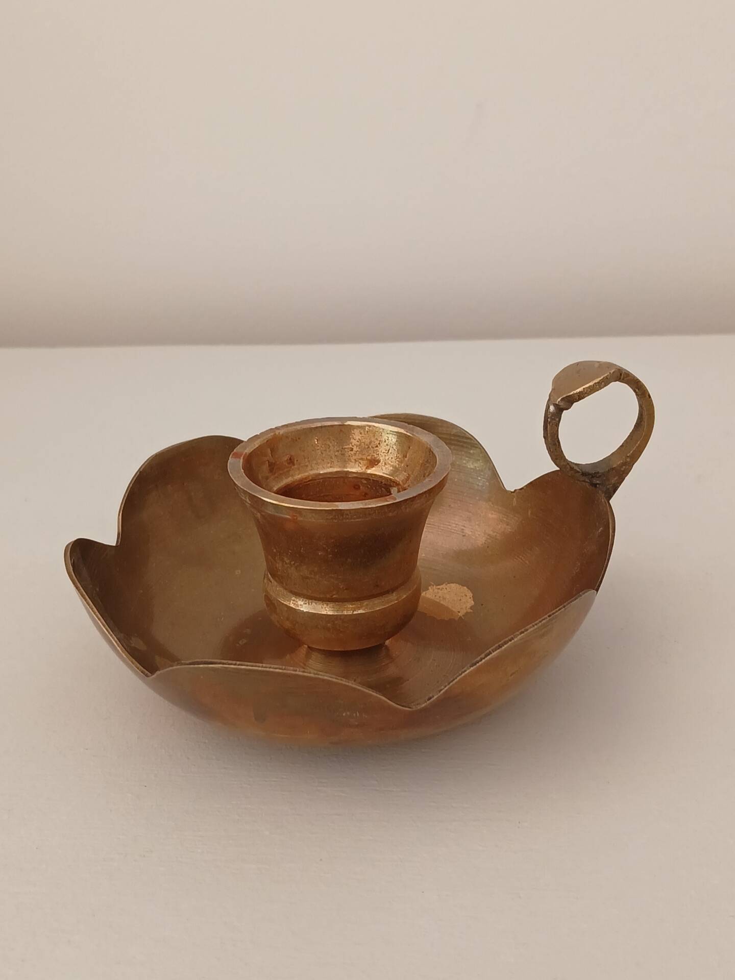 Brass candle holder in the shape of a flower.