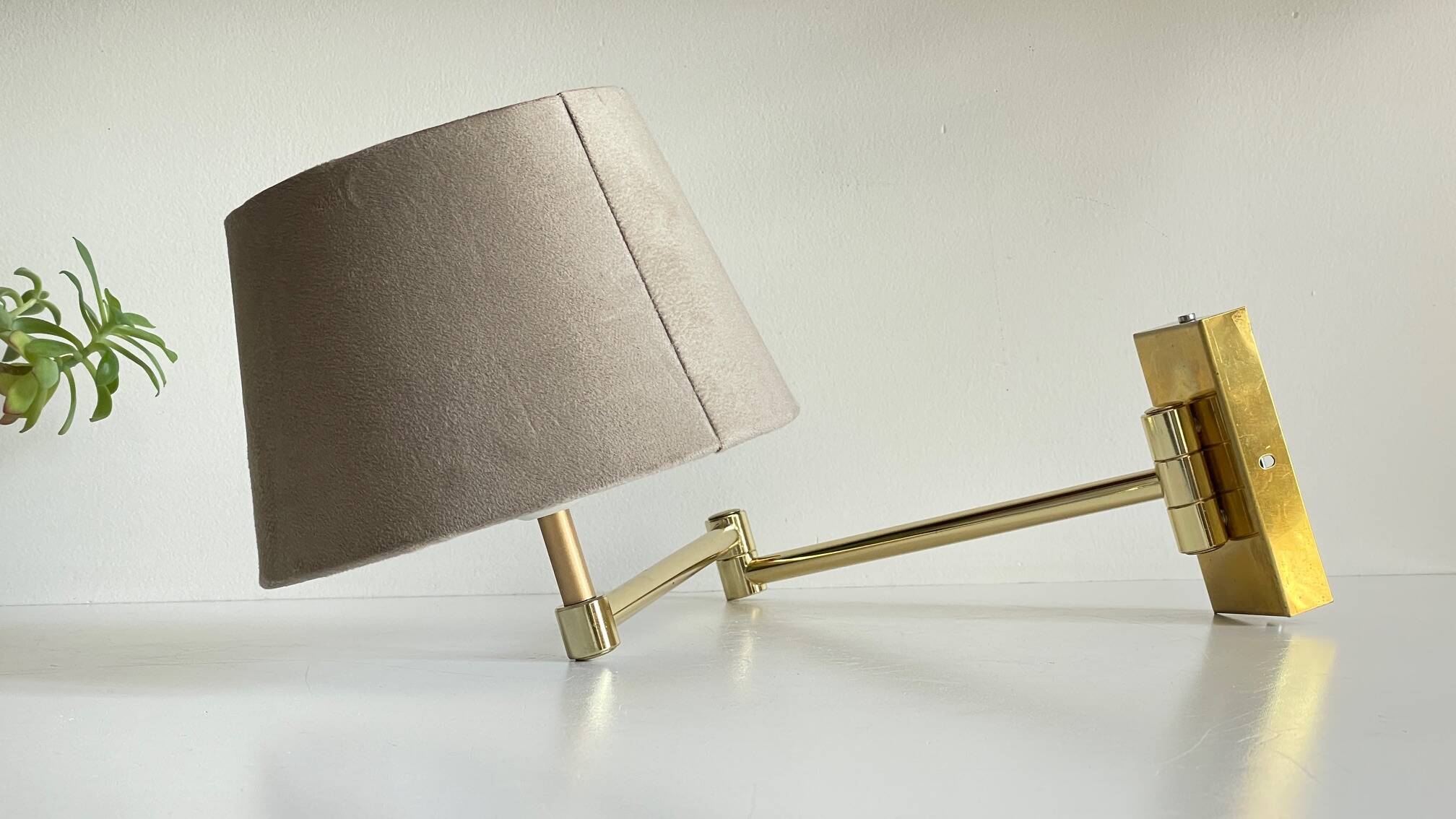 articulated brass and velvet wall light