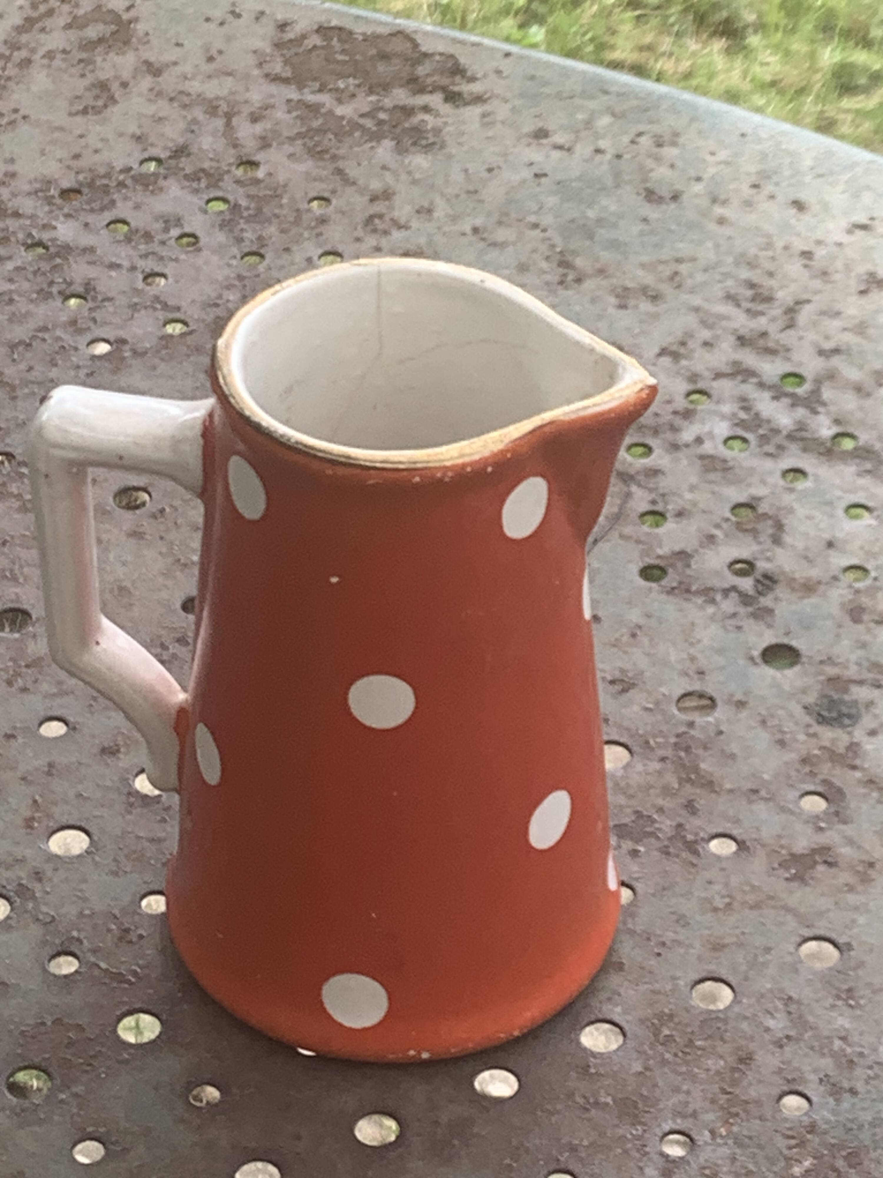 Milk jug, pitcher with white polka dots on orange earthenware, Sarreguemines and Digoin