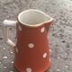 Milk jug, pitcher with white polka dots on orange earthenware, Sarreguemines and Digoin
