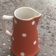 Milk jug, pitcher with white polka dots on orange earthenware, Sarreguemines and Digoin
