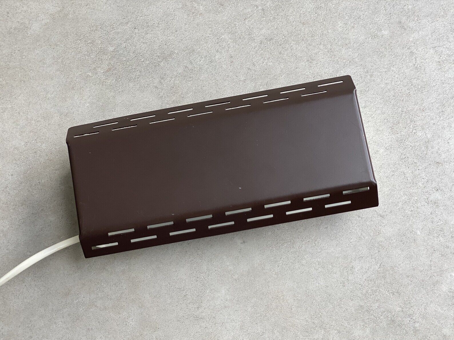 Wall sconce with a perforated shade