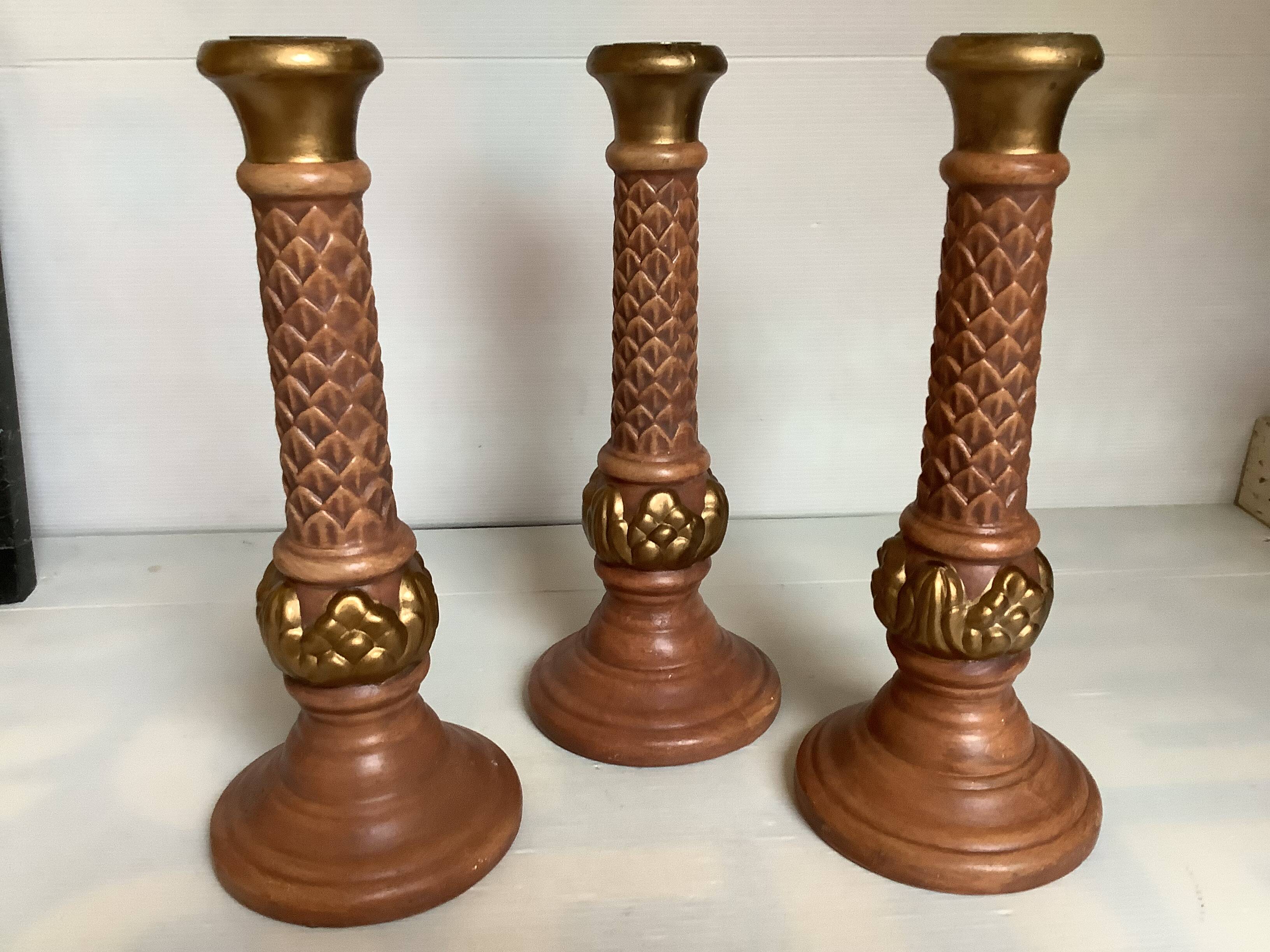 Trio of large brown and gold candlesticks