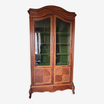 Glass bookcase with gendarme hat