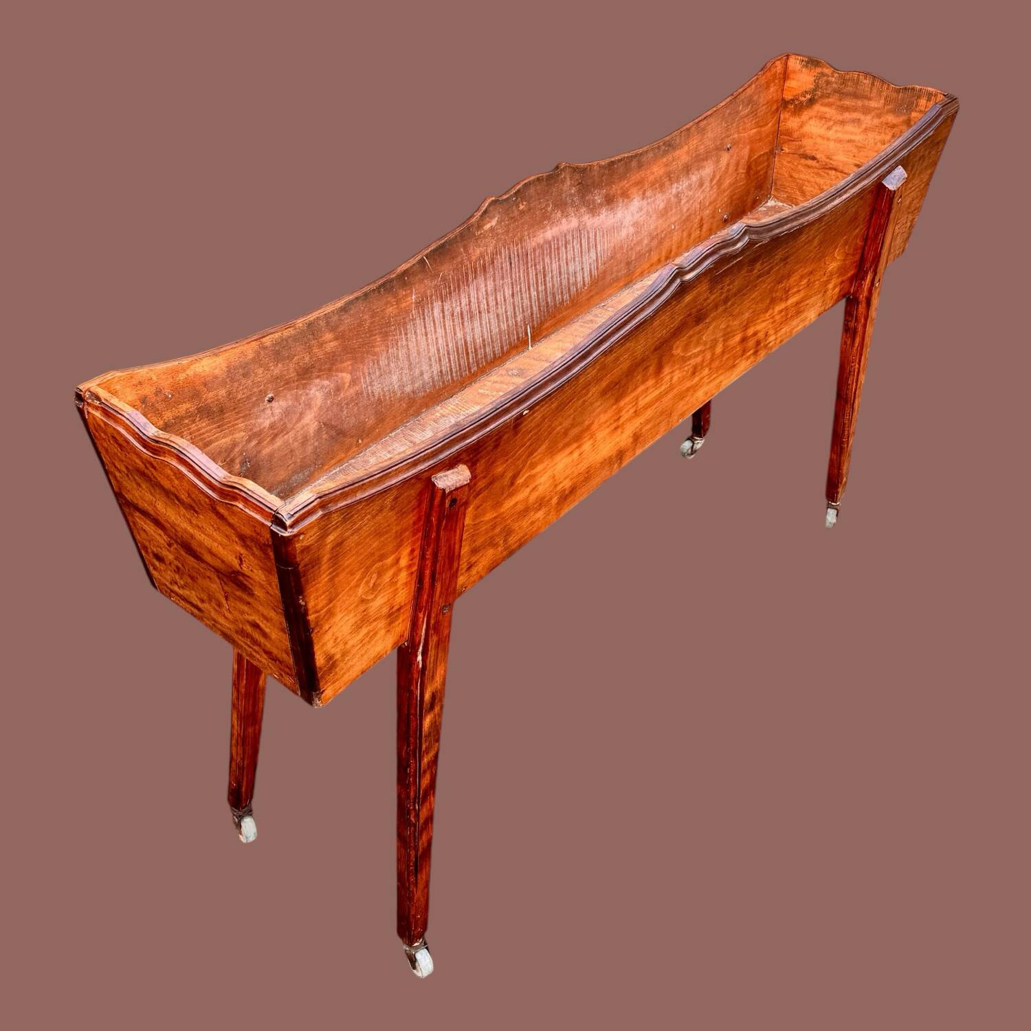 Old indoor planter on wheels