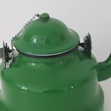 Old green kettle in enamelled metal