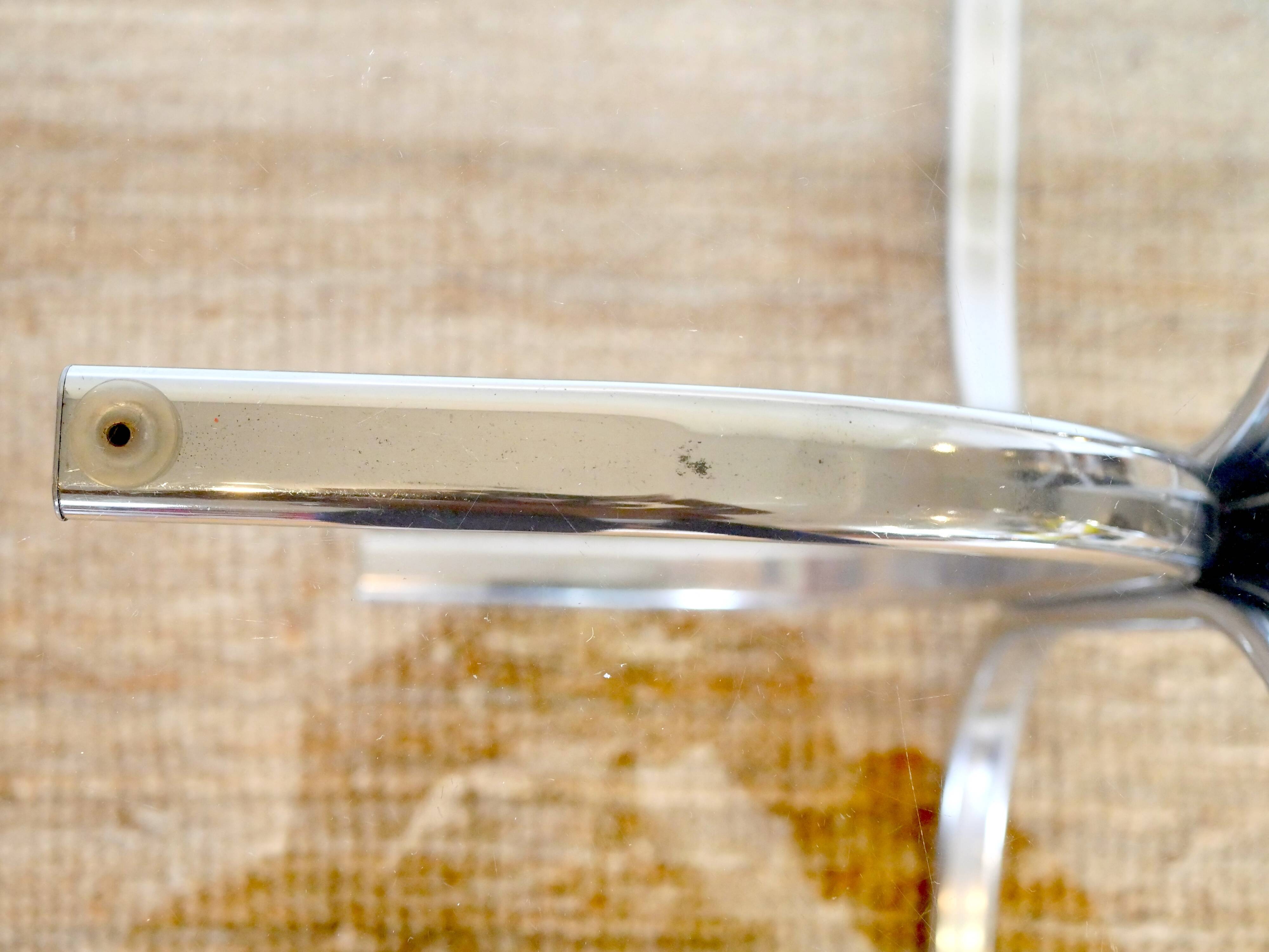 Dining table with smoked glass top and chrome base.