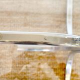 Dining table with smoked glass top and chrome base.