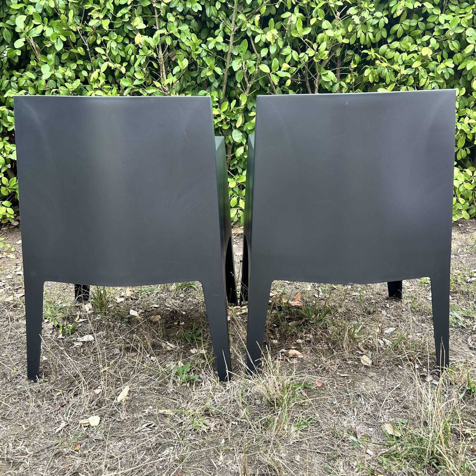 2 black Toy chairs designed by Starck