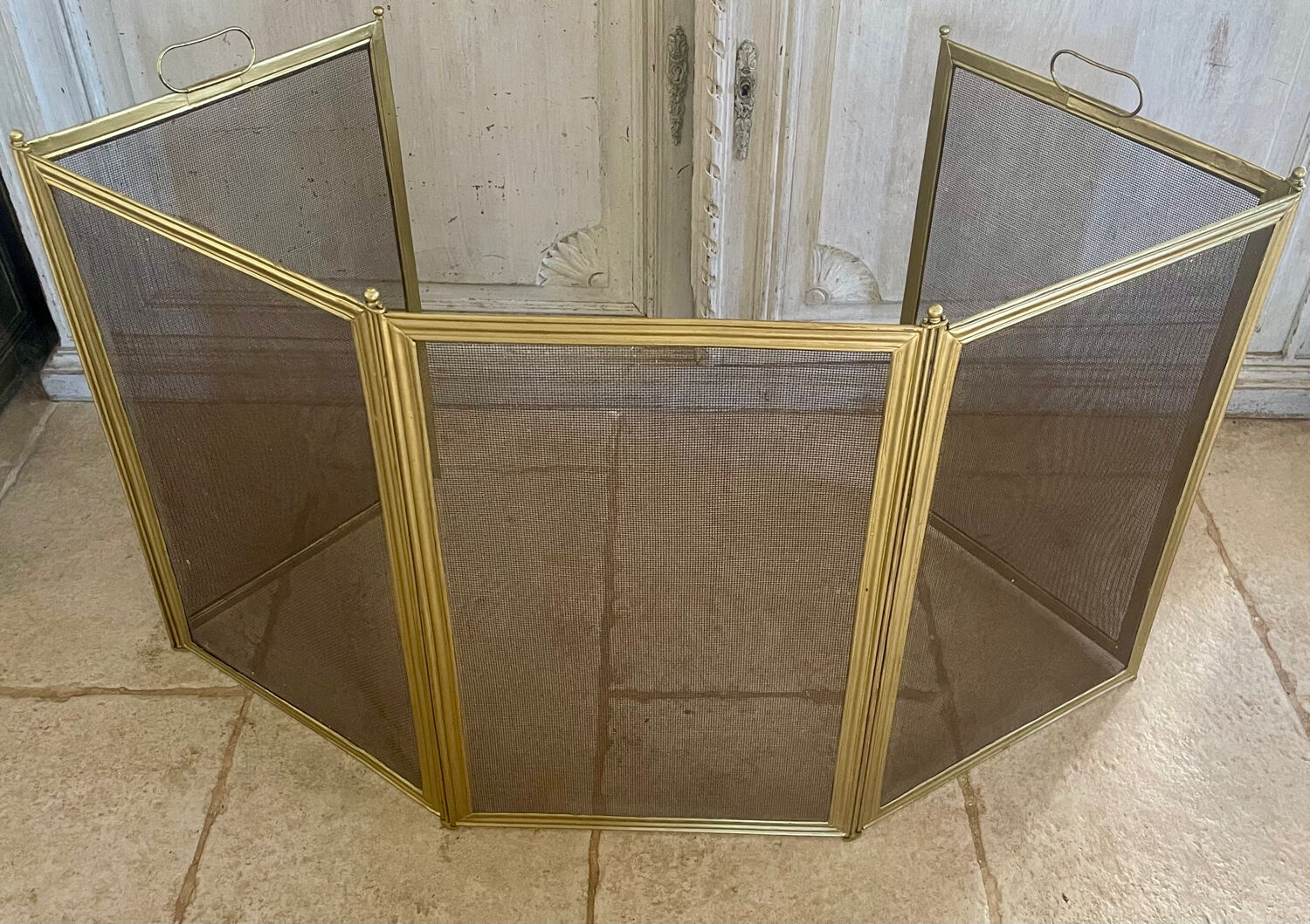 Five-panel golden metal fireplace screen from the 19th century.