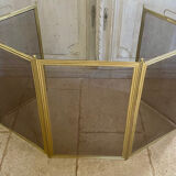 Five-panel golden metal fireplace screen from the 19th century.